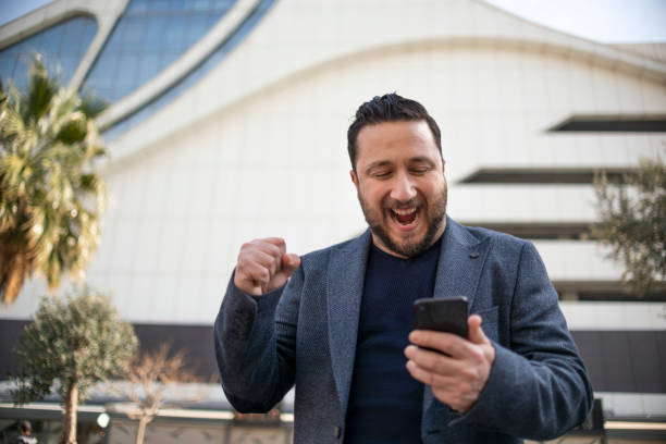 istock Ecstatic businessman learning good news on smartphone 1307223188