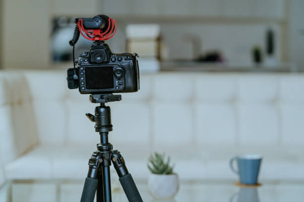 istock Camera with microphone on the tripod in the living room 1307223230