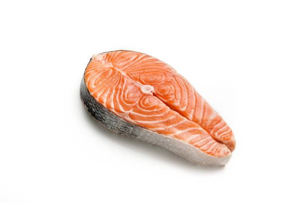 Raw red fish steak isolated on white background. Raw red fish steak isolated on white background. Salmon steak close-up. salmon stock pictures, royalty-free photos & images