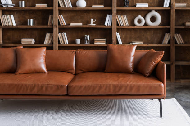 istock Room with comfortable couch and books on bookshelves 1307223821