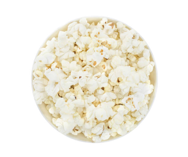 istock Popcorn corn cooked, in a white bowl, isolated on white background with clipping path. Top view. 1307224486