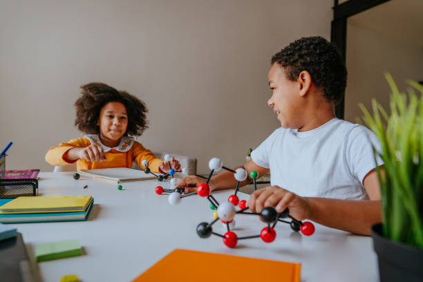 istock Boy and girl making molecular model lerning chemistry science 1307224568
