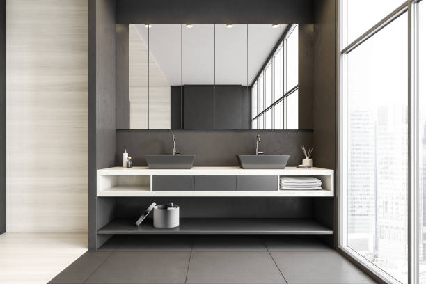 istock Grey and white bathroom with two sinks, mirror and big window 1307226495