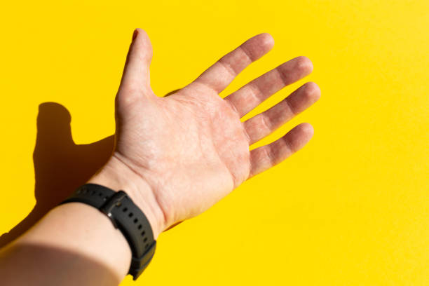 istock Man's palm against yellow background 1307228022