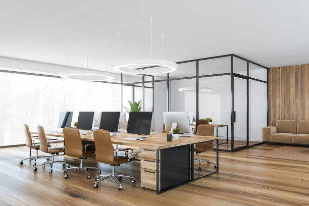 istock Wooden office room with armchairs and table with computer 1307228390