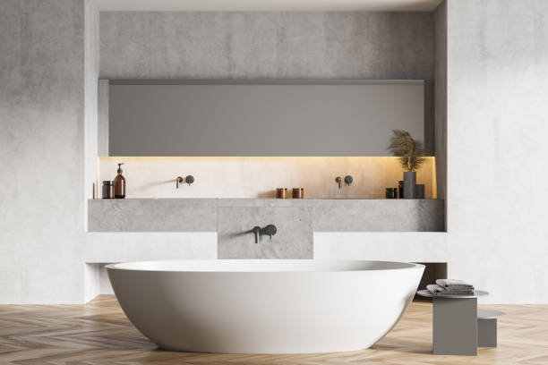 istock Light grey bathroom with white bathtub, parquet floor and grey wall 1307229516