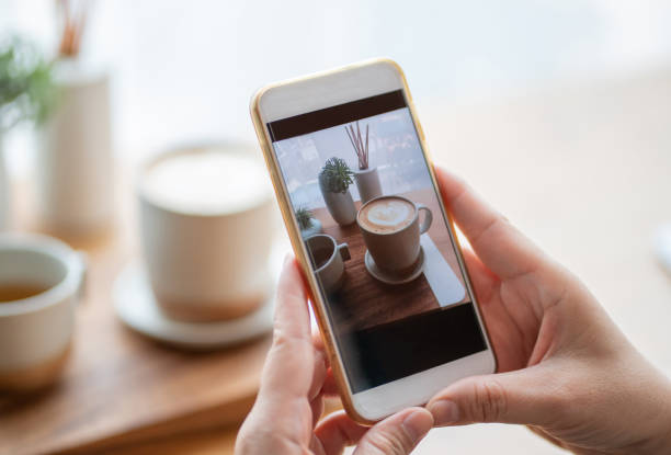 istock woman using smartphone taking photo coffee on table 1307229617