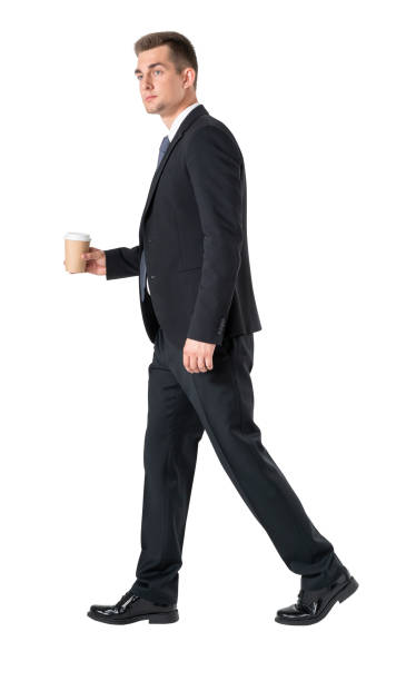 istock Businessman with coffee walking, isolated over white background 1307230936