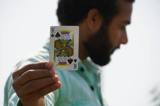 man with playing cards showing King Card - Poker concept