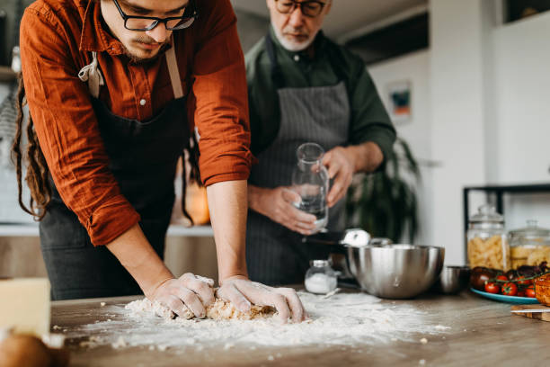 istock Father and son preparing pasta dough at their domestic kitchen 1307231322
