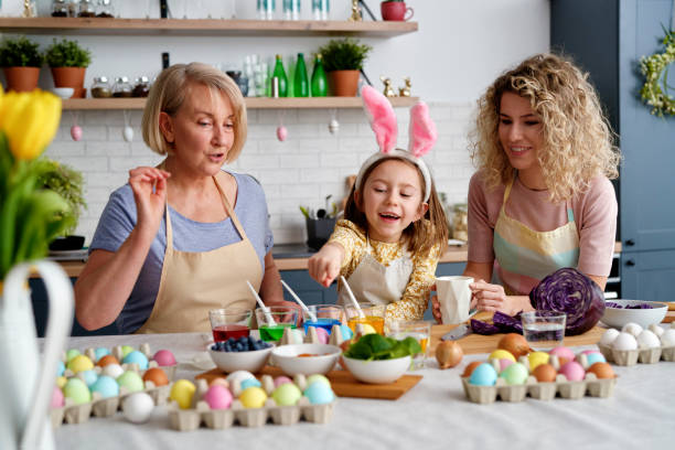 istock Front view of three generations of woman during coloring eggs 1307236391