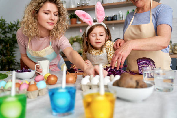 istock Three generation of women prepare natural dyes for coloring eggs 1307238082