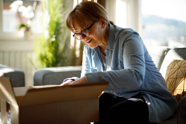 istock Excited senior woman opens package delivery 1307238151