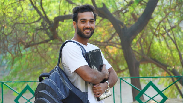 istock Cheerful Young student with laptop looking 1307238181