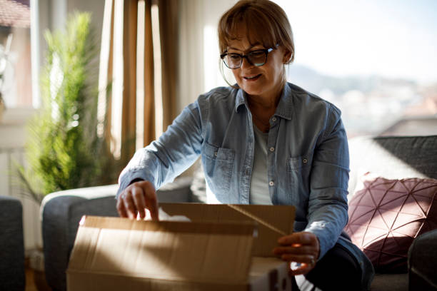 istock Excited senior woman opens package delivery 1307238211