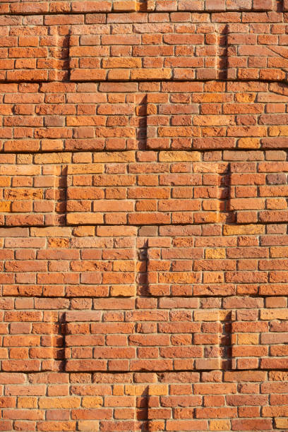 istock Textured brick wall in sunlight. background. copy space. Free space for text 1307239345
