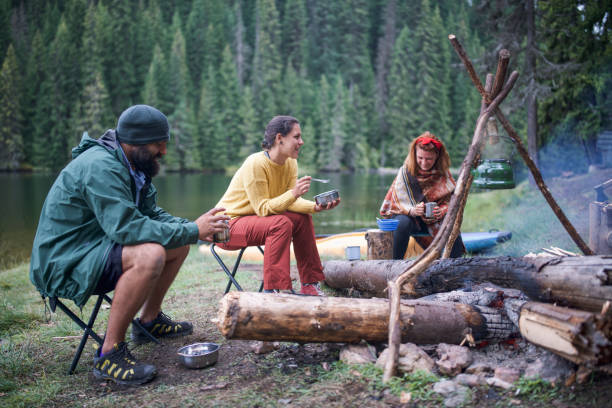 istock Group of friends having a breakfast and talking while camping in the mountain. 1307239745