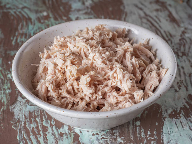 istock Shredded chicken in a deep plate for making salad 1307240788