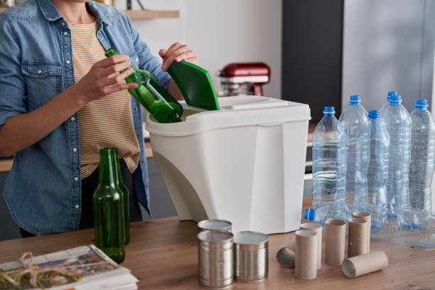 istock Woman segregating garbage at home 1307242448