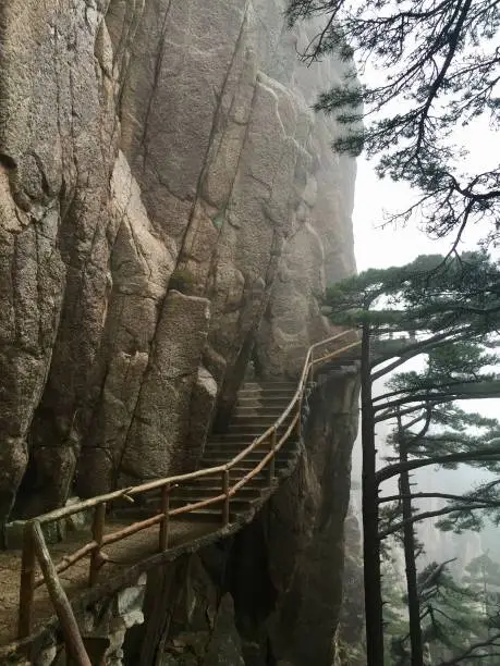 China Mount HuangShan - April, 2015: Natural scenery, sea of clouds, peculiarly-shaped granite peaks, Huangshan pine trees and views of grand canyon. Photo taken in Yellow Mountain (UNESCO).