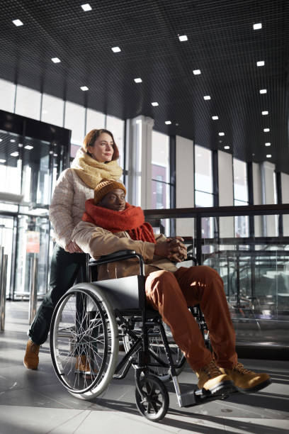 istock Interabled Couple Entering Shopping Mall 1307244413