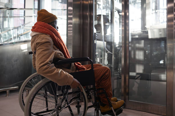 African American Wheelchair User Waiting for Elevator