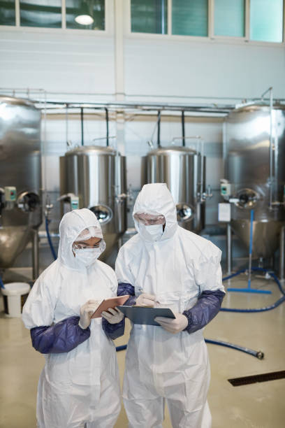 istock Two Chemical Plant Workers Supervising Production 1307245463