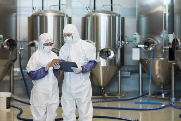 istock Two Workers Supervising Production at Chemical Plant 1307245481
