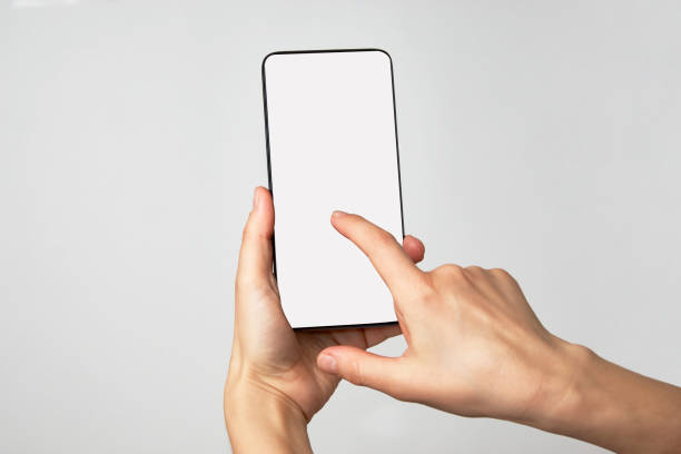 istock Woman hand holding phone on white background with copy space 1307245793
