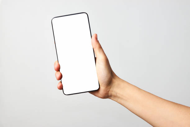 istock Woman hand holding phone on white background with copy space 1307245816
