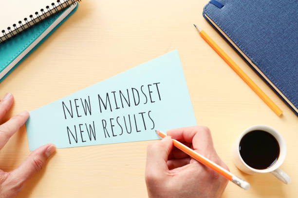 istock concept image with new mindset new results text. top view of office table 1307247226