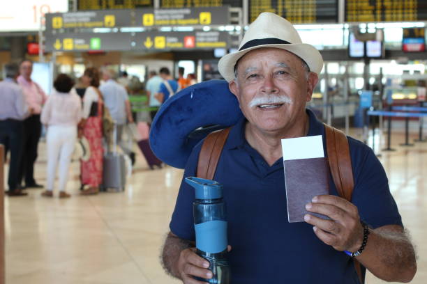 Senior man showing boarding pass and passport