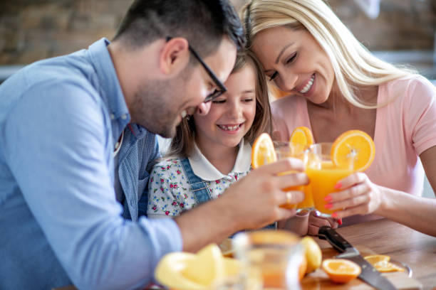 istock Family making fresh orange juice together 1307249726