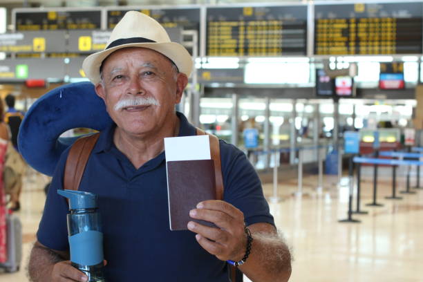 istock Senior man showing boarding pass and passport 1307249732