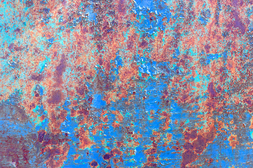Rusty old painted metal background. Cracked texture. Corrosion of metal.