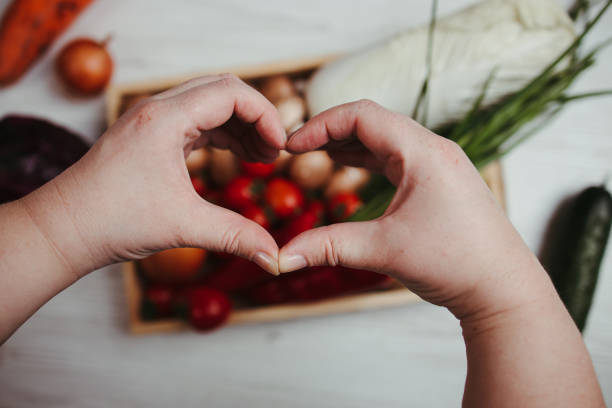 istock Hands making heart sign on vegetable background 1307250263