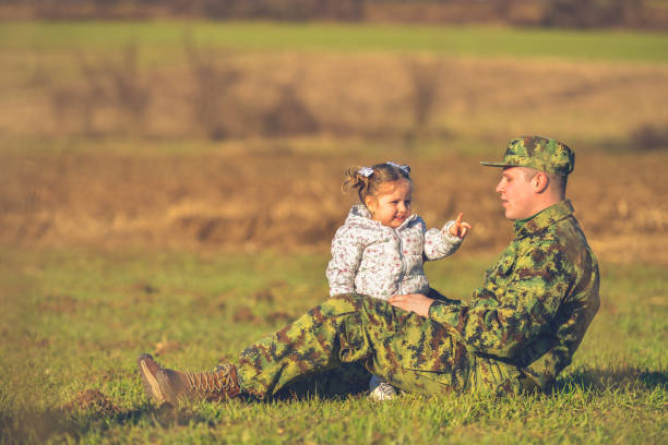 istock Happy dad lying on grass and holding daughter on straight 1307251141