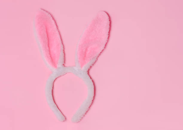 istock Funny Easter bunny ears on pink background. Top view. Copy space for text.Happy Easter, 1307254422