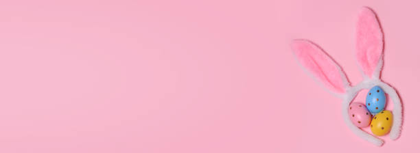 istock Easter decorated eggs, decorative bunny ears on a pink background.Top view. Copy space for text.Banner.Happy Easter, 1307254458