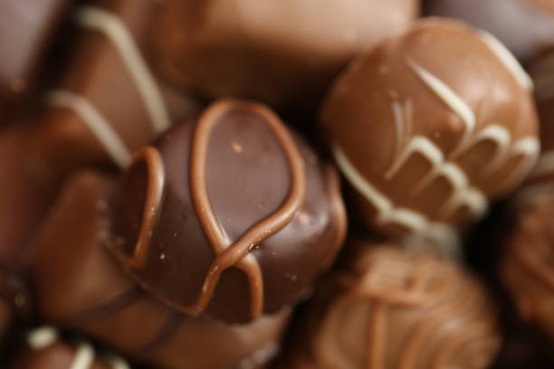 istock Chocolates assortment.Chocolate sweets.Chocolate pattern. Candy close-up on a brown background.dark milk chocolates set 1307254564