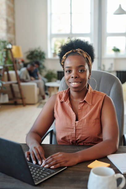istock Successful young African female freelancer looking at you during work in home office 1307256282