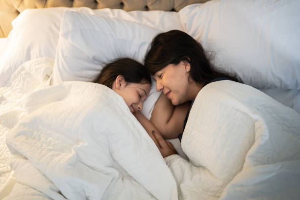 istock Mother and daughter sleeping at home 1307257159