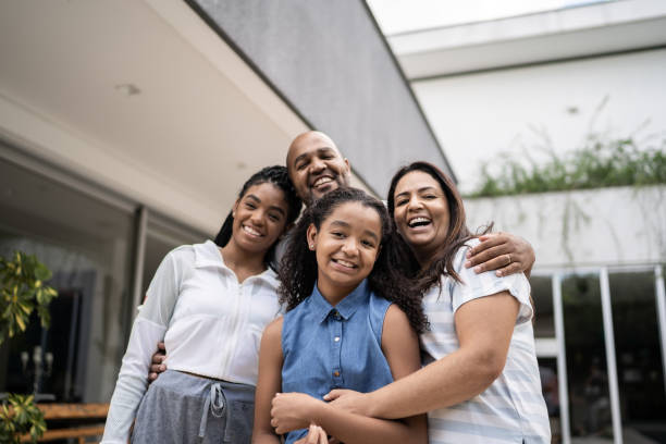 retrato de una familia feliz frente a la casa - happiness family outdoors house fotografías e imágenes de stock
