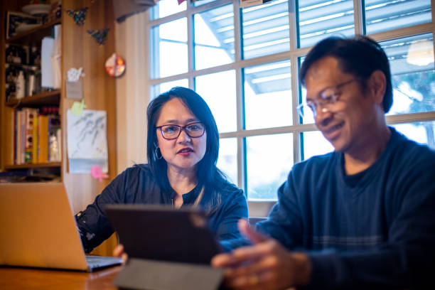 istock Asian Couple with Glasses working at home 1307260572
