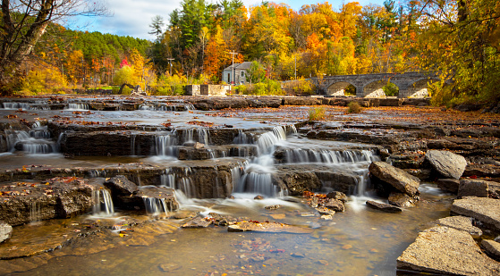 Waterfall cascades down rocks in lush forest