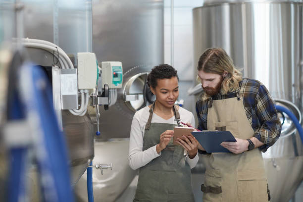 istock Two Young People Controlling Production at Plant 1307263817