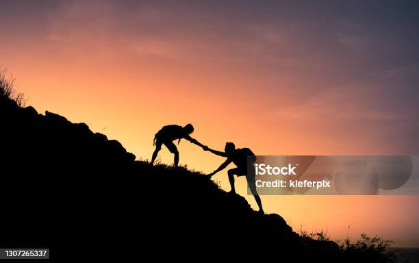 Young People On Mountain Hike Stock Photo - Download Image Now - Assistance, Support, Mountain Climbing