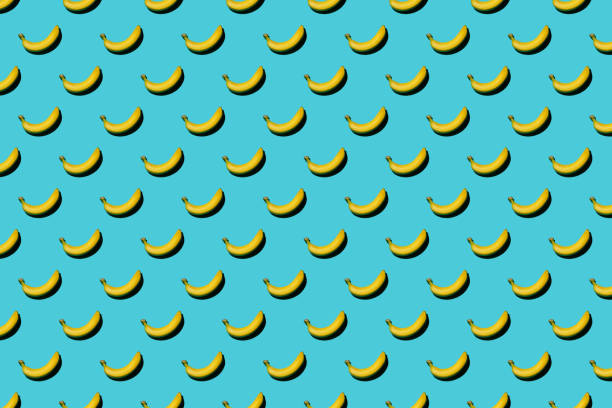 istock Trendy pattern made with fresh fruits on bright light blue background. Minimal style with colorful paper backdrop. Colorful photo. Flat lay. Minimal creative concept. Food background. Bananas 1307266136
