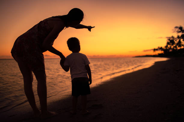 Mother with son enjoying sunset.