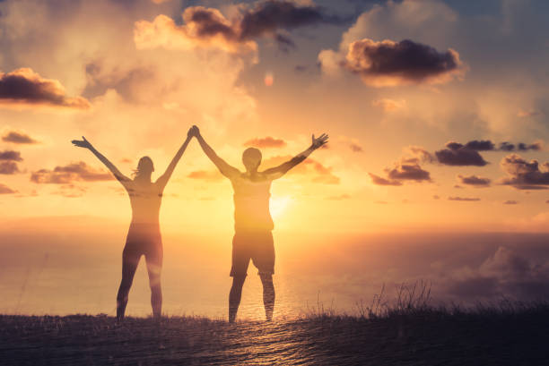 istock Couple hikers celebrating success 1307266231